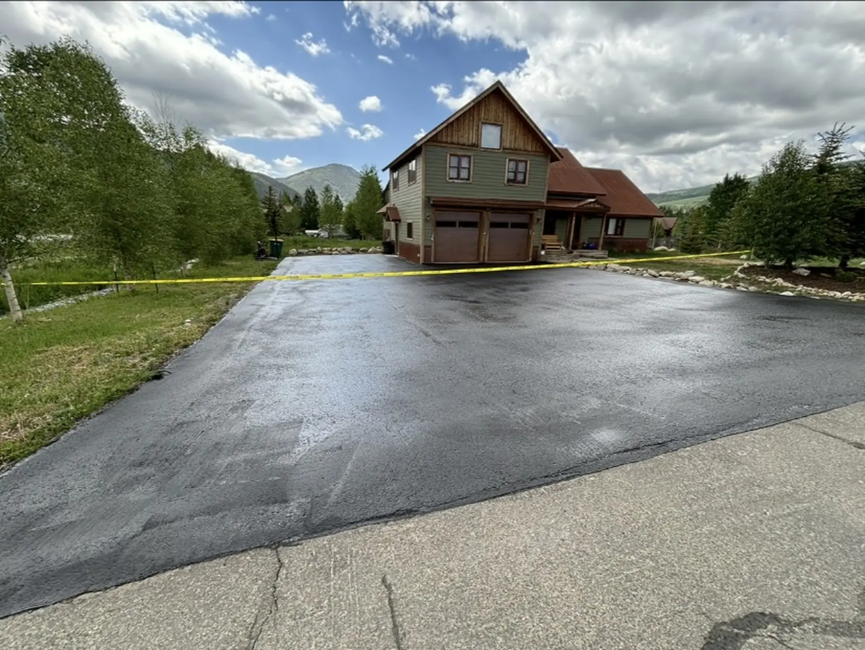 Newly paved residential driveway in front of a Colorado mountain home